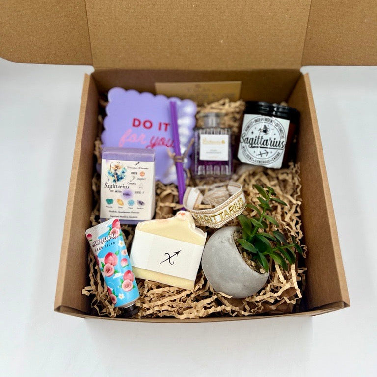 Sagittarius Gift box containing various items including a candle, soap, and small plants