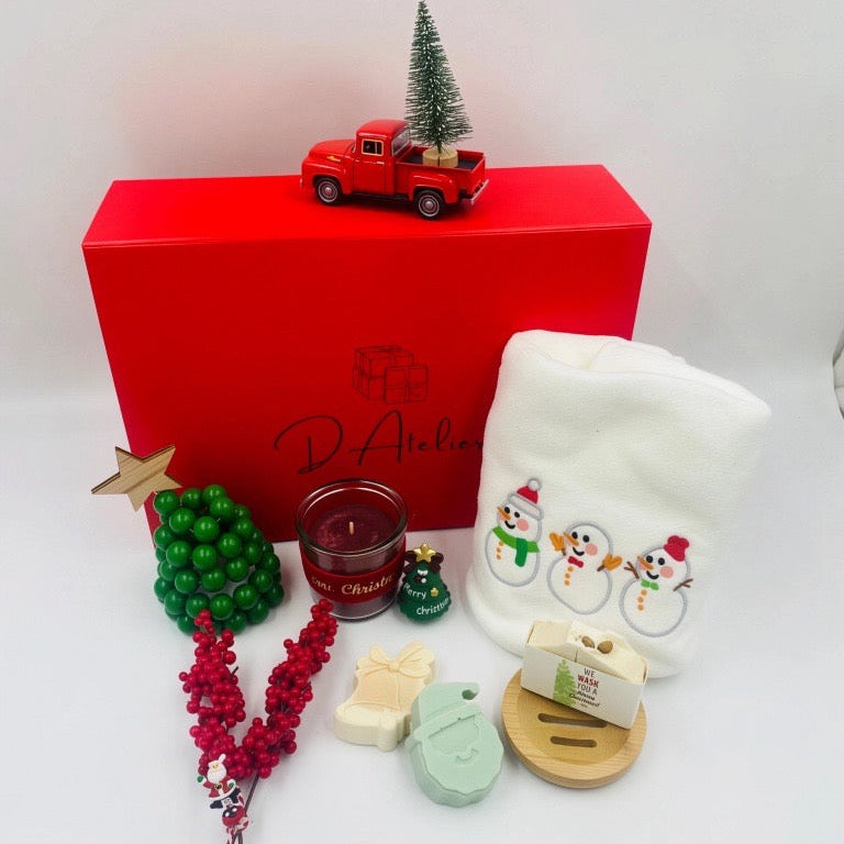 Christmas-themed items including a red box, candle, and decorative items, Christmas towel, natural handmade Soaps.