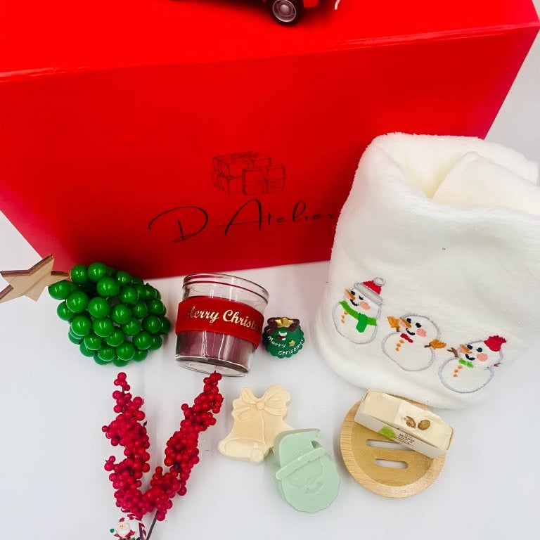 Christmas-themed items including a red box, candle, and decorative items, Christmas towel, natural handmade Soaps.