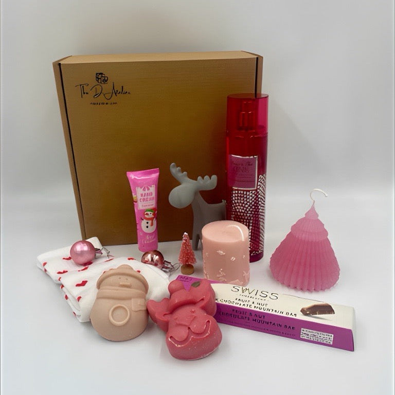 Collection of products including a box, hand ream, pink Candles, Natural handmade soaps, Body Spray from Victoria's secret, heart shape sock, chocolate from M&S.