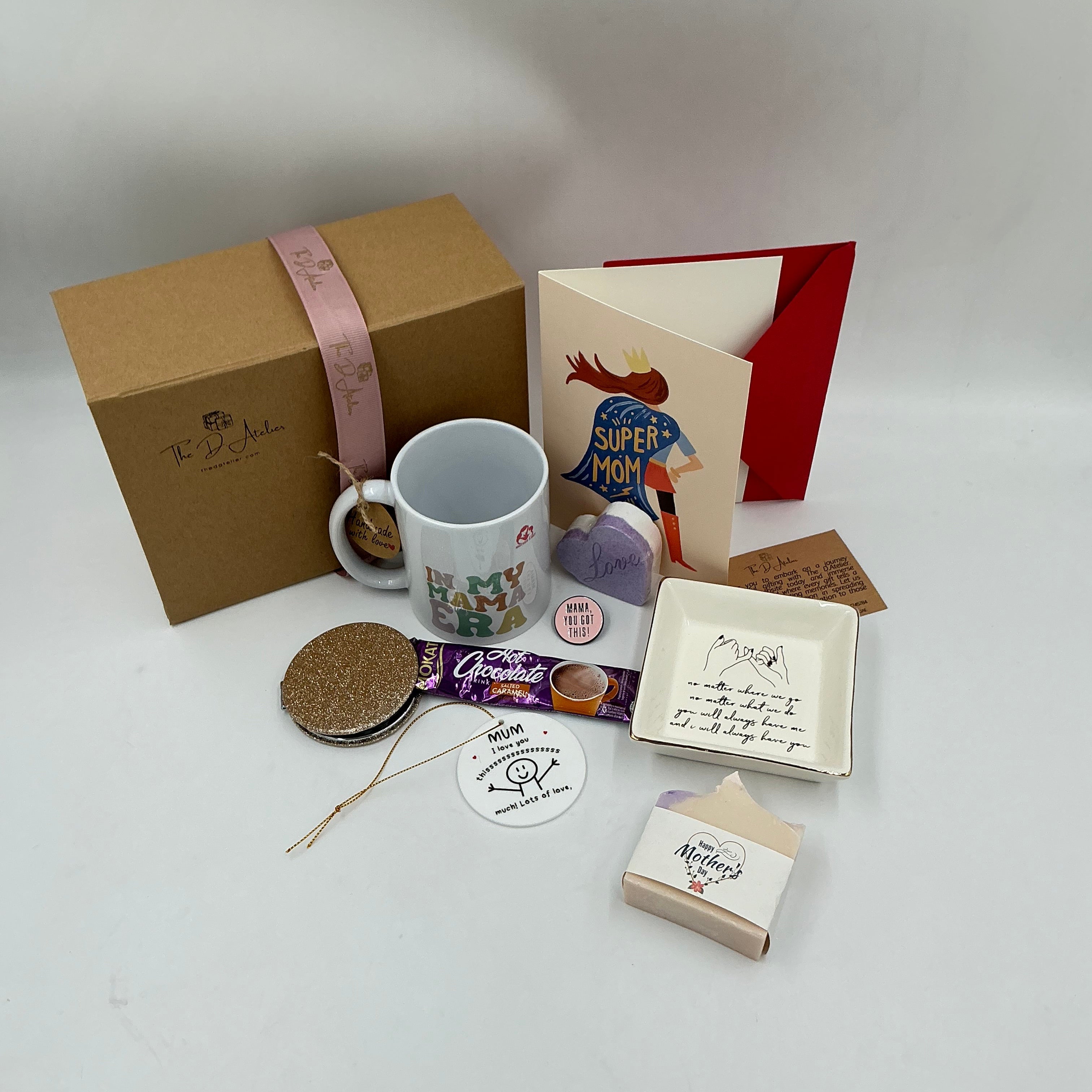 Collection of items including a mug, cards, and a box on a light gray background