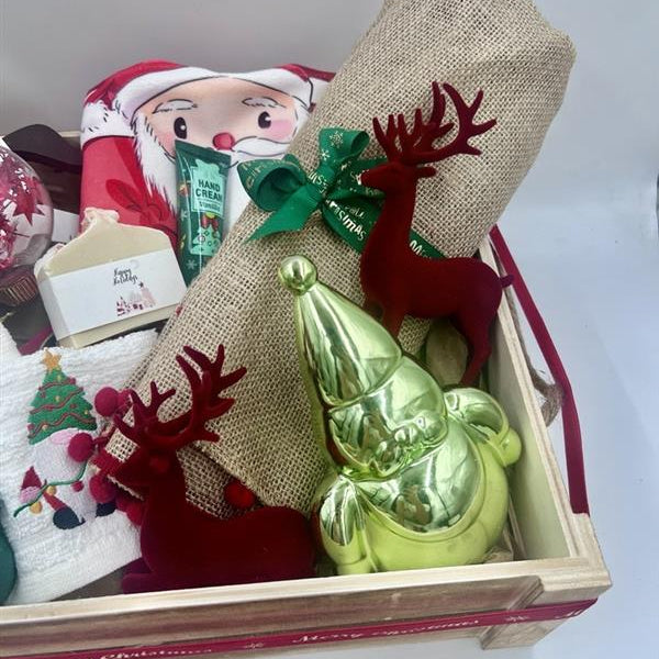 

Inside, you'll find a delightful assortment of carefully selected items:

- A charming large wooden nutcracker on a horse, perfect for adding a touch of Christmas spirit to your decor.
- A kitchen towel; featuring a cheerful Santa face, sure to brighten up your cooking space.
