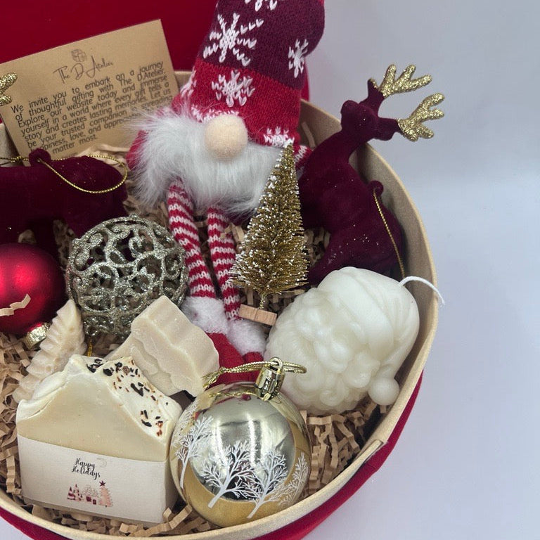 Decorative gift basket with Christmas-themed items including a gnome, ornaments, and a candle.