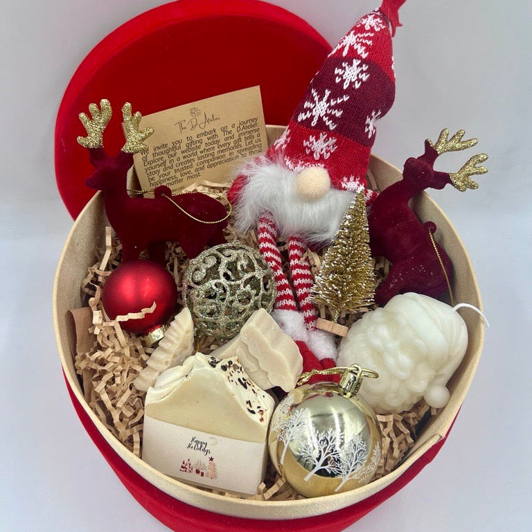 Decorative gift set with a gnome, ornaments, and a card in a box on a white background