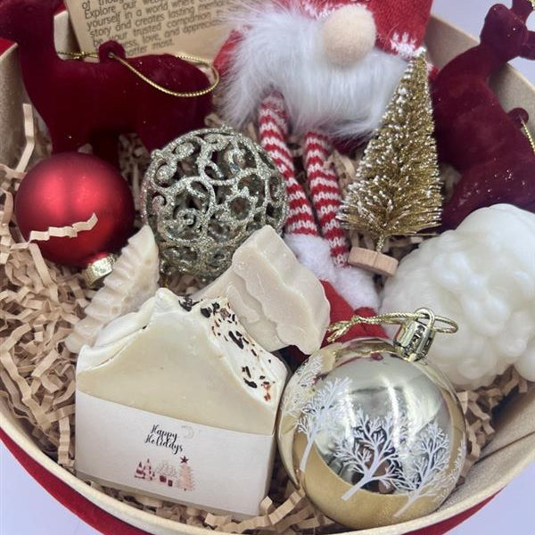 Decorative items including a soap, ornaments, and a small tree in a box.