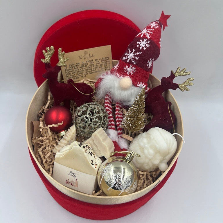 Decorative Christmas gift set with gnome, ornaments, and a red box on a white background