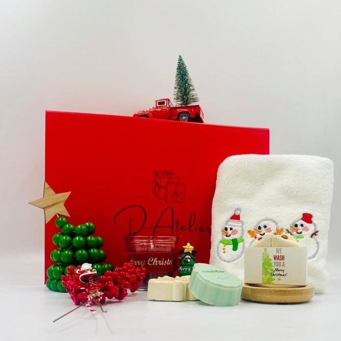 Christmas-themed items including a red box, candle, and decorative items, Christmas towel, natural handmade Soaps.