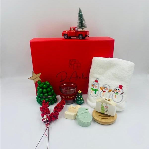 Christmas-themed items including a red box, candle, and decorative items, Christmas towel, natural handmade Soaps.