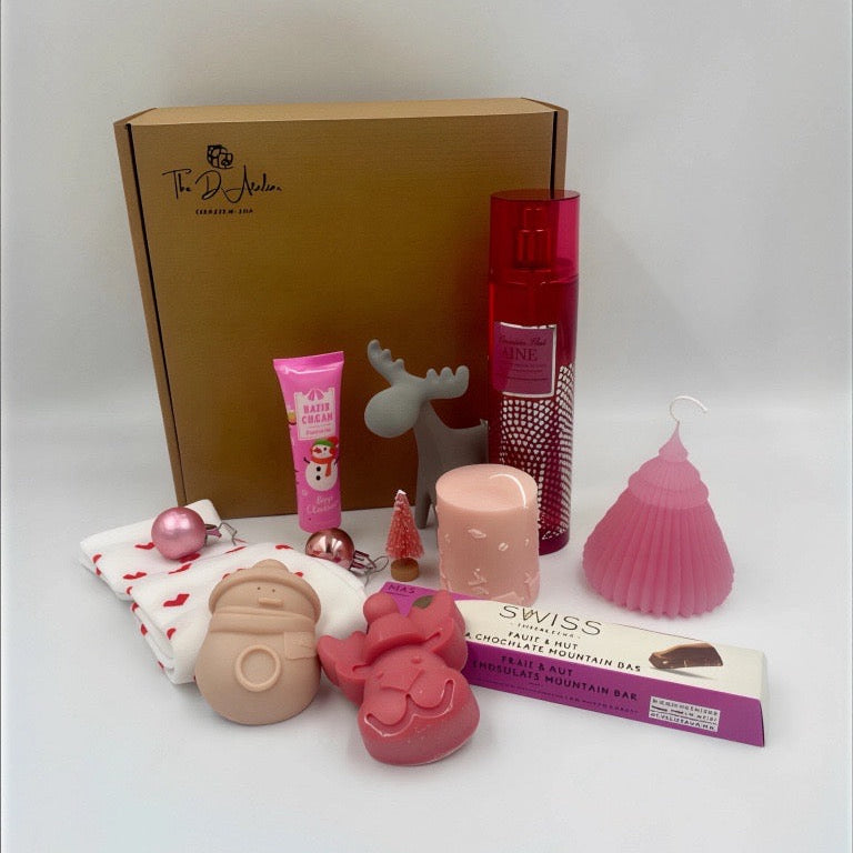Collection of products including a box, hand ream, pink Candles, Natural handmade soaps, Body Spray from Victoria's secret, heart shape sock, chocolate from M&S. 