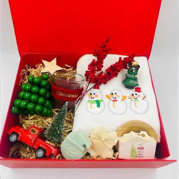 Christmas-themed items including a red box, candle, and decorative items, Christmas towel, natural handmade Soaps.