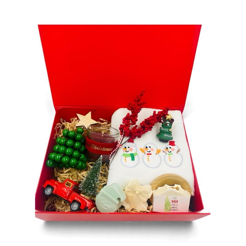 Christmas-themed items including a red box, candle, and decorative items, Christmas towel, natural handmade Soaps.