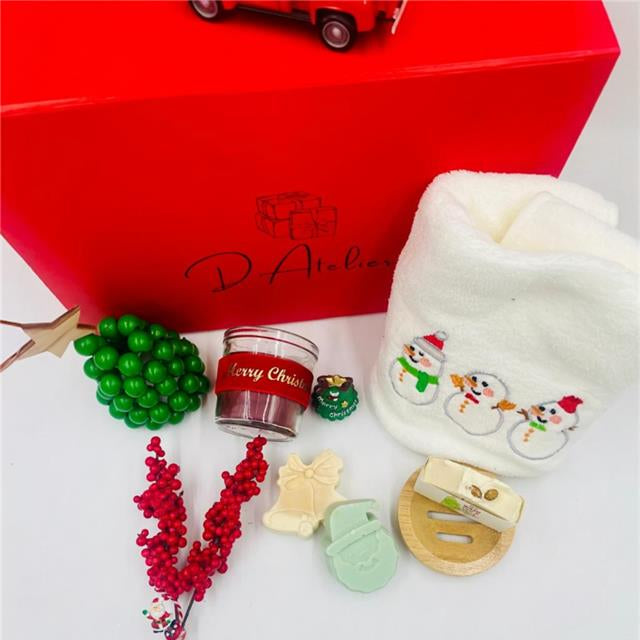 Christmas-themed items including a red box, candle, and decorative items, Christmas towel, natural handmade Soaps.